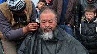 A migrant barber shaves the Chinese artist Ai Weiwei's head