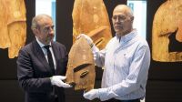 Hermann Parzinger (L), President of the Prussian Cultural Heritage Foundation, and John Johnson from the Chugach Alaska Corporation, hold a wooden object from Berlin's Ethnological Museum during a restitution ceremony in Berlin on May 16, 2018.
Germany has returned nine artefacts belonging to indigenous people in Alaska, after determining that they were plundered from graves. The Prussian Cultural Heritage Foundation, which oversees museums in the German capital, said the burial objects were brought to Berlin in 1882-1884 on commission by the then Royal Museum of Ethnology, but "everything showed today that the objects stemmed from a grave robbery and not from an approved archaeological dig". / AFP PHOTO / dpa / Ralf Hirschberger / Germany OUT
