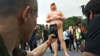 People take photos of a statue of a naked Republican presidential candidate Donald Trump Thursday, Aug. 18, 2016, in New York's Union Square. The statue was removed by New York City Department of Parks &amp; Recreation employees. (AP Photo/Mary Altaffer)