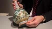 A rare Imperial Qianlong porcelain vase (18th century) is displayed at Sotheby's auction company in Paris, on May 22, 2018. 
The vase, which was stored in a shoebox in an attic for decades, will be sold at Sotheby's Paris on June. / AFP PHOTO / Thomas SAMSON