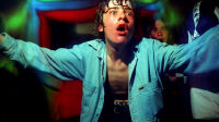 Gurning raver wearing an open denim shirt with arms in the air, The Pleasuredome, Skegness, UK, 12th April 1997