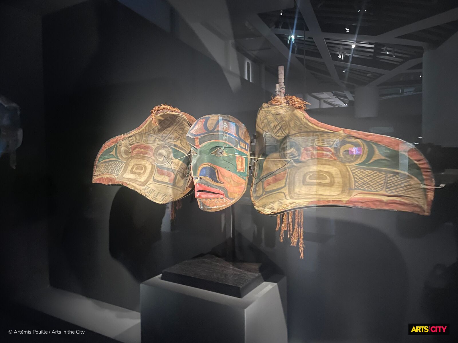 Masque à transformation ouvert, ailes déployées et visage peint, suspendu dans la pénombre, exposition Premières Nations au musée du quai Branly - Jacques Chirac