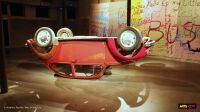 Exposition Walid Raad au CENTQUATRE-PARIS - la Coccinelle retournée (image à la une) La Coccinelle Volkswagen retournée de Walid Raad devant une tenture couverte d'inscriptions, exposition au CENTQUATRE-PARIS
